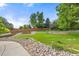 Landscaped backyard with lush green grass and decorative rocks at 6524 Surry Pl, Parker, CO 80134