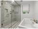 Modern bathroom with a large glass-enclosed shower, a soaking tub, and elegant fixtures at 6524 Surry Pl, Parker, CO 80134