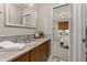 Bathroom boasts marble countertops, custom wood cabinets, and a view into the adjacent bedroom at 6524 Surry Pl, Parker, CO 80134