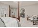 Bedroom featuring a four-poster bed, a fireplace with a mirror, and a cozy sitting area at 6524 Surry Pl, Parker, CO 80134