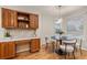 Charming breakfast nook showcases custom wood cabinets, built in desk space, and a window-side table and chairs at 6524 Surry Pl, Parker, CO 80134