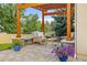 Beautiful covered patio features wood pergola, stone columns, and comfortable outdoor seating at 6524 Surry Pl, Parker, CO 80134