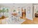 Bright dining room featuring hardwood floors and a view into the open kitchen at 6524 Surry Pl, Parker, CO 80134
