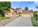 Charming home featuring a stone facade, two-car garage, and manicured landscaping at 6524 Surry Pl, Parker, CO 80134
