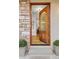 Elegant front door leading to a bright, open interior with hardwood floors at 6524 Surry Pl, Parker, CO 80134