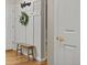 Hallway with bench and coat hooks, white paneled wall with a 'Welcome' sign at 6524 Surry Pl, Parker, CO 80134