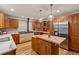 Spacious kitchen with custom wood cabinets, stainless steel appliances and a butcher block kitchen island at 6524 Surry Pl, Parker, CO 80134