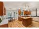 Open kitchen boasts custom wood cabinets, a kitchen island with butcher block and stainless steel appliances at 6524 Surry Pl, Parker, CO 80134