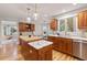 Bright kitchen with custom cabinets, kitchen island with marble and butcher block countertops, and stainless steel appliances at 6524 Surry Pl, Parker, CO 80134