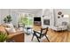 Bright living room with hardwood floors, fireplace, and sliding glass door to the backyard at 6524 Surry Pl, Parker, CO 80134