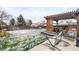 Spacious backyard with a pergola-covered patio and green lawn offers a great space for relaxation and recreation at 4512 S Yank St, Morrison, CO 80465