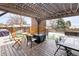 Charming backyard features a pergola-covered patio, perfect for outdoor dining and enjoying the serene surroundings at 4512 S Yank St, Morrison, CO 80465
