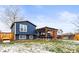 Well maintained backyard featuring a covered patio and a fenced yard with scattered snow at 4512 S Yank St, Morrison, CO 80465