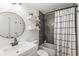 Tastefully designed bathroom with modern vanity, updated fixtures, and tiled shower with tub at 4512 S Yank St, Morrison, CO 80465