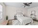 A well lit neutral bedroom with a ceiling fan, stylish rug, bench and side tables at 4512 S Yank St, Morrison, CO 80465