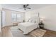 Bright bedroom featuring a ceiling fan, large window, stylish rug, and a neutral color palette at 4512 S Yank St, Morrison, CO 80465