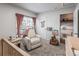 Comfortable bedroom featuring a chair, side table, and natural light from the window at 4512 S Yank St, Morrison, CO 80465