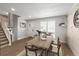 Bright dining area featuring a wood table, modern chairs, and a large window for natural light at 4512 S Yank St, Morrison, CO 80465