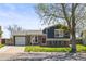 Charming two-story home with brick and dark siding, attached garage, and landscaped front yard at 4512 S Yank St, Morrison, CO 80465
