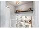Bright foyer featuring a shelf, staircase, white-painted brick, and a comfortable living area at 4512 S Yank St, Morrison, CO 80465