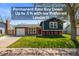 Charming two-story home featuring a well-manicured lawn, brick accents, and a vibrant red front door at 4512 S Yank St, Morrison, CO 80465