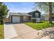 Inviting exterior view of a two-story home, with a lush lawn and a paved driveway leading to an attached garage at 4512 S Yank St, Morrison, CO 80465