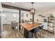 Bright kitchen with breakfast bar, modern lighting, and open access to the living room at 4512 S Yank St, Morrison, CO 80465