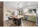 Well-lit kitchen boasting an eat-in island, backyard access, and stainless steel appliances at 4512 S Yank St, Morrison, CO 80465