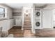 Practical laundry area with stacked washer/dryer next to stairs with patterned risers combines style and functionality at 4512 S Yank St, Morrison, CO 80465