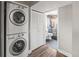 Practical laundry area with stacked washer and dryer and easy access to updated bathroom at 4512 S Yank St, Morrison, CO 80465