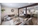 Open-concept living room with wood flooring, a comfortable seating arrangement, and a view into the kitchen at 4512 S Yank St, Morrison, CO 80465