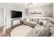 Inviting living room showcasing a large sectional couch, round rug, and TV for comfortable entertainment at 4512 S Yank St, Morrison, CO 80465