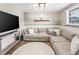 Spacious living room with a comfortable sectional sofa and modern accents offers a cozy gathering space at 4512 S Yank St, Morrison, CO 80465