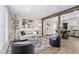 Inviting living room with stylish decor, a shiplap accent wall, and an open layout with hardwood flooring at 4512 S Yank St, Morrison, CO 80465