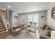 Comfortable living room with neutral-toned furniture, plank walls, and a staircase nearby at 4512 S Yank St, Morrison, CO 80465