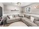 Comfortable living room features a sectional sofa, wooden accents, and a large window offering natural light at 4512 S Yank St, Morrison, CO 80465