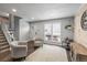 Stylish living room with neutral decor, modern furnishings, and a bright window offering natural light at 4512 S Yank St, Morrison, CO 80465