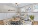 Basement living room featuring a sectional sofa, modern coffee table and wainscotting at 4512 S Yank St, Morrison, CO 80465