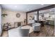 Open-concept living room with wood flooring, a comfortable seating arrangement, and a view into the kitchen at 4512 S Yank St, Morrison, CO 80465
