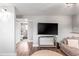 Bright living space with wood floors includes an open-concept view of an adjacent bathroom and access to the backyard at 4512 S Yank St, Morrison, CO 80465