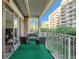 Cozy outdoor balcony with seating, offering a charming space to relax and enjoy the surrounding views of building and greenery at 955 Eudora Street St # 108E, Denver, CO 80220