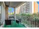 Serene balcony seating with a view of lush greenery and the building's facade, creating a peaceful outdoor retreat at 955 Eudora Street St # 108E, Denver, CO 80220