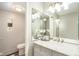 Well-lit bathroom with marble vanity top, modern vanity, large mirror, and neutral walls at 955 Eudora Street St # 108E, Denver, CO 80220