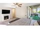 Comfortable bedroom featuring fireplace, balcony with furniture, neutral walls, and ceiling fan at 955 Eudora Street St # 108E, Denver, CO 80220