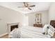 Comfortable bedroom featuring fireplace, accent wall, comfortable bed, and ceiling fan at 955 Eudora Street St # 108E, Denver, CO 80220