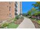 Exterior shot of a walkway and garden with a view of the high-rise building at 955 Eudora Street St # 108E, Denver, CO 80220