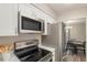 Clean kitchen featuring stainless steel appliances, white cabinets, and marble countertops at 955 Eudora Street St # 108E, Denver, CO 80220