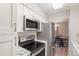 Modern kitchen featuring stainless steel appliances, white cabinets, and marble countertops at 955 Eudora Street St # 108E, Denver, CO 80220