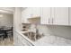 Bright kitchen sink with modern faucet, double basin, white cabinetry, and faux marble countertops at 955 Eudora Street St # 108E, Denver, CO 80220
