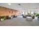 Bright and airy lounge area featuring comfortable seating, brick accent wall, and ample natural light from large windows at 955 Eudora Street St # 108E, Denver, CO 80220